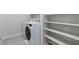 Laundry area featuring new washer, dryer, and a built-in shelving unit at 7432 Red Plumeria Ave, Las Vegas, NV 89113