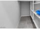 Corner storage with light tile floors and multiple shelves for organization at 7432 Red Plumeria Ave, Las Vegas, NV 89113