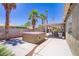 The backyard includes a covered patio, a hot tub, desert landscaping, and privacy walls at 7713 White Grass Ave, Las Vegas, NV 89131