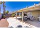 Covered patio, backyard desert landscaping and comfortable furniture in this backyard view at 7713 White Grass Ave, Las Vegas, NV 89131