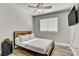 Relaxing bedroom with a TV, comfortable bed, ceiling fan, and natural light at 7713 White Grass Ave, Las Vegas, NV 89131