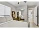 Comfortable bedroom with a mirrored closet, ceiling fan, and a window view at 7713 White Grass Ave, Las Vegas, NV 89131