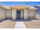 Inviting front entryway with a decorative security door, neutral stucco, and desert landscaping at 7713 White Grass Ave, Las Vegas, NV 89131