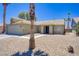 Single story home showcasing low-maintenance desert landscaping and palm trees against a blue sky at 7713 White Grass Ave, Las Vegas, NV 89131