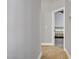Neutral hallway with tile flooring leading to a bedroom with a modern bed frame at 7713 White Grass Ave, Las Vegas, NV 89131