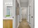 Hallway with an adjacent sink, modern fixtures, and multiple entry doors at 7713 White Grass Ave, Las Vegas, NV 89131