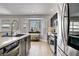 Modern kitchen design featuring stainless steel appliances, tile flooring, and natural light at 7713 White Grass Ave, Las Vegas, NV 89131