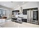Updated kitchen featuring stainless steel appliances, modern black cabinets, and quartz countertops at 7713 White Grass Ave, Las Vegas, NV 89131