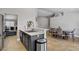 Bright, open kitchen boasts a quartz countertop, stainless steel appliances, and tile flooring at 7713 White Grass Ave, Las Vegas, NV 89131