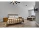 Spacious primary bedroom featuring wood-look flooring, a ceiling fan, and large window at 7713 White Grass Ave, Las Vegas, NV 89131