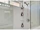 Updated shower with a glass door, built-in shelves, and modern fixtures at 7713 White Grass Ave, Las Vegas, NV 89131