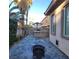 Inviting backyard with a built-in bar, stylish tiled patio, tall trees and a cozy fire pit at 7728 Villa De La Paz Ave, Las Vegas, NV 89131