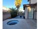 A backyard is perfect for outdoor living with a hot tub, built in bar, fire pit and palm trees at 7728 Villa De La Paz Ave, Las Vegas, NV 89131
