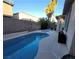 Inviting backyard with a swimming pool, hot tub, patio, lush landscaping and privacy wall at 7728 Villa De La Paz Ave, Las Vegas, NV 89131