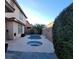 Backyard oasis with a pool and hot tub surrounded by lush landscaping, perfect for relaxation and recreation at 7728 Villa De La Paz Ave, Las Vegas, NV 89131