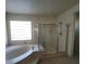 Modern bathroom featuring a soaking tub and a separate glass-enclosed shower at 7728 Villa De La Paz Ave, Las Vegas, NV 89131