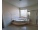 Bright bathroom with soaking tub, separate shower and tiled floor at 7728 Villa De La Paz Ave, Las Vegas, NV 89131