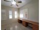 Bedroom with ceiling fan and built-in desk area and plantation shutters at 7728 Villa De La Paz Ave, Las Vegas, NV 89131
