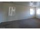 Spacious bedroom featuring large windows and plush carpeting at 7728 Villa De La Paz Ave, Las Vegas, NV 89131