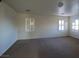 Well-lit bedroom featuring large windows and plush carpeting at 7728 Villa De La Paz Ave, Las Vegas, NV 89131