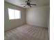 Bedroom featuring a window and a ceiling fan with carpet at 7728 Villa De La Paz Ave, Las Vegas, NV 89131