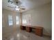 Bedroom with ceiling fan and built-in desk area and plantation shutters at 7728 Villa De La Paz Ave, Las Vegas, NV 89131