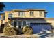 Charming two-story home featuring an attached garage and well-maintained landscaping at 7728 Villa De La Paz Ave, Las Vegas, NV 89131