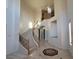 Entryway with winding staircase, high ceiling, decorative floors, and wrought iron railing at 7728 Villa De La Paz Ave, Las Vegas, NV 89131