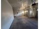 Spacious garage with room for vehicles and storage, including mounted fixtures and a garage door opener at 7728 Villa De La Paz Ave, Las Vegas, NV 89131