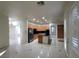 Open kitchen with stainless appliances, wood cabinets, and a center island with black countertop at 7728 Villa De La Paz Ave, Las Vegas, NV 89131
