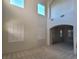 Spacious Living Room featuring high ceilings, multiple windows with shutters, and neutral carpet at 7728 Villa De La Paz Ave, Las Vegas, NV 89131