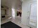 Open concept living area with tile flooring, fireplace, and access to the kitchen at 7728 Villa De La Paz Ave, Las Vegas, NV 89131