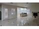 Living room with tile floors, plantation shutters, and fireplace near a kitchenette space at 7728 Villa De La Paz Ave, Las Vegas, NV 89131