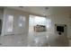 Living room with tile floors, plantation shutters, and fireplace near a kitchenette space at 7728 Villa De La Paz Ave, Las Vegas, NV 89131