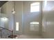 A light-filled foyer with soaring ceilings, staircase and decorative tiled floor pattern at 7728 Villa De La Paz Ave, Las Vegas, NV 89131