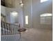A light-filled foyer with soaring ceilings, staircase and decorative tiled floor pattern at 7728 Villa De La Paz Ave, Las Vegas, NV 89131