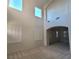 Spacious Living Room featuring high ceilings, multiple windows with shutters, and neutral carpet at 7728 Villa De La Paz Ave, Las Vegas, NV 89131