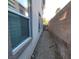 Narrow side yard featuring gravel ground covering, a block wall, and access gate to the backyard at 7728 Villa De La Paz Ave, Las Vegas, NV 89131