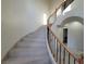 Curved staircase featuring decorative iron railing, marble steps and tiled floors at 7728 Villa De La Paz Ave, Las Vegas, NV 89131