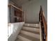 Elegant staircase with wood railing and black iron spindles at 7728 Villa De La Paz Ave, Las Vegas, NV 89131