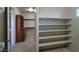 Walk-in closet with multiple racks and storage cabinets, leading into the bathroom at 7728 Villa De La Paz Ave, Las Vegas, NV 89131