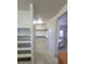 Walk-in closet leading to a bathroom featuring a tub and glass enclosed shower at 7728 Villa De La Paz Ave, Las Vegas, NV 89131