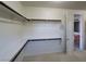Walk-in closet with clothing racks, leading into a bathroom at 7728 Villa De La Paz Ave, Las Vegas, NV 89131
