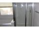 Bathroom featuring glass enclosed shower stall, tub, and window, creating a bright and functional space at 780 Vortex Ave, Henderson, NV 89002