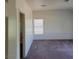 Large bedroom with neutral walls, wood-look floors, and bright window at 780 Vortex Ave, Henderson, NV 89002