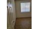 Bedroom with neutral walls, window with blinds, and tile flooring, showcasing a clean and simple design at 780 Vortex Ave, Henderson, NV 89002