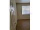 Bedroom with neutral walls, window with blinds, and tile flooring, showcasing a clean and simple design at 780 Vortex Ave, Henderson, NV 89002