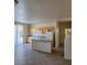 Bright eat-in kitchen with a breakfast bar island, light cabinets, and access to the backyard at 780 Vortex Ave, Henderson, NV 89002
