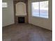 Living room with a cozy fireplace, tile flooring, and a bright window at 780 Vortex Ave, Henderson, NV 89002