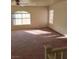 Bright living room featuring neutral walls, ceiling fan, and abundant natural light from multiple windows at 780 Vortex Ave, Henderson, NV 89002